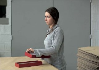 Sabrina, ouvrière sur fond gris, photographie couleur, Olivia Gay